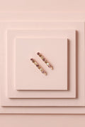 Glow On & Sparkle Gemstone Bobby Pins on a stack of pink boxes 