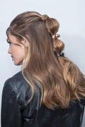 The Hair Edit gunmetal & gold orb duo dual-sphere metal hair tie accessory worn by blonde medium length haired female model