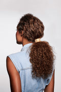 The Hair Edit Hair Accessories Ponytail Studded Cuff Textured Metal Hair Tie in Soft Gold Color styled in ponytail & worn by curly hair dark brunette model
