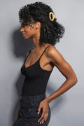 woman wearing ellipse oval hair claw clip in caramel marble in hair